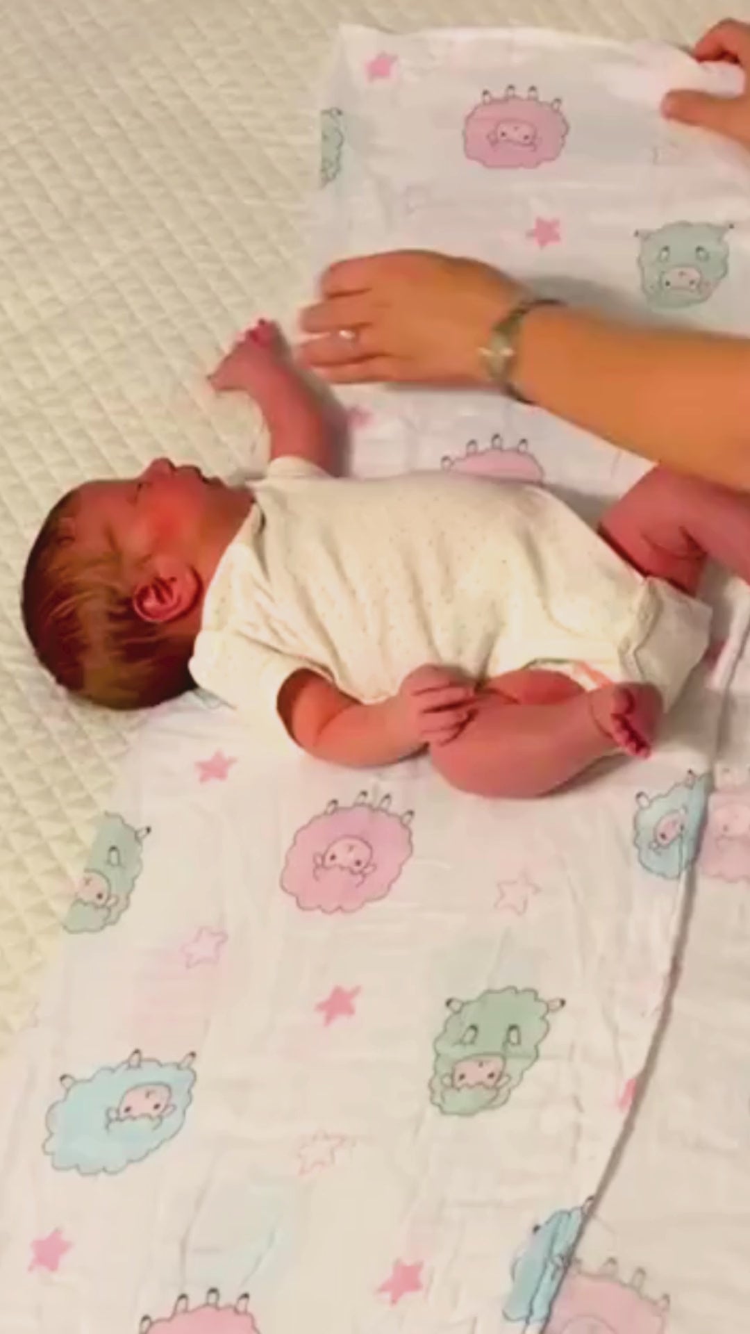Load video: miekki bamboo cotton swaddle blanket tutorial – mom swaddling newborn baby for comfort, safety, and better sleep.